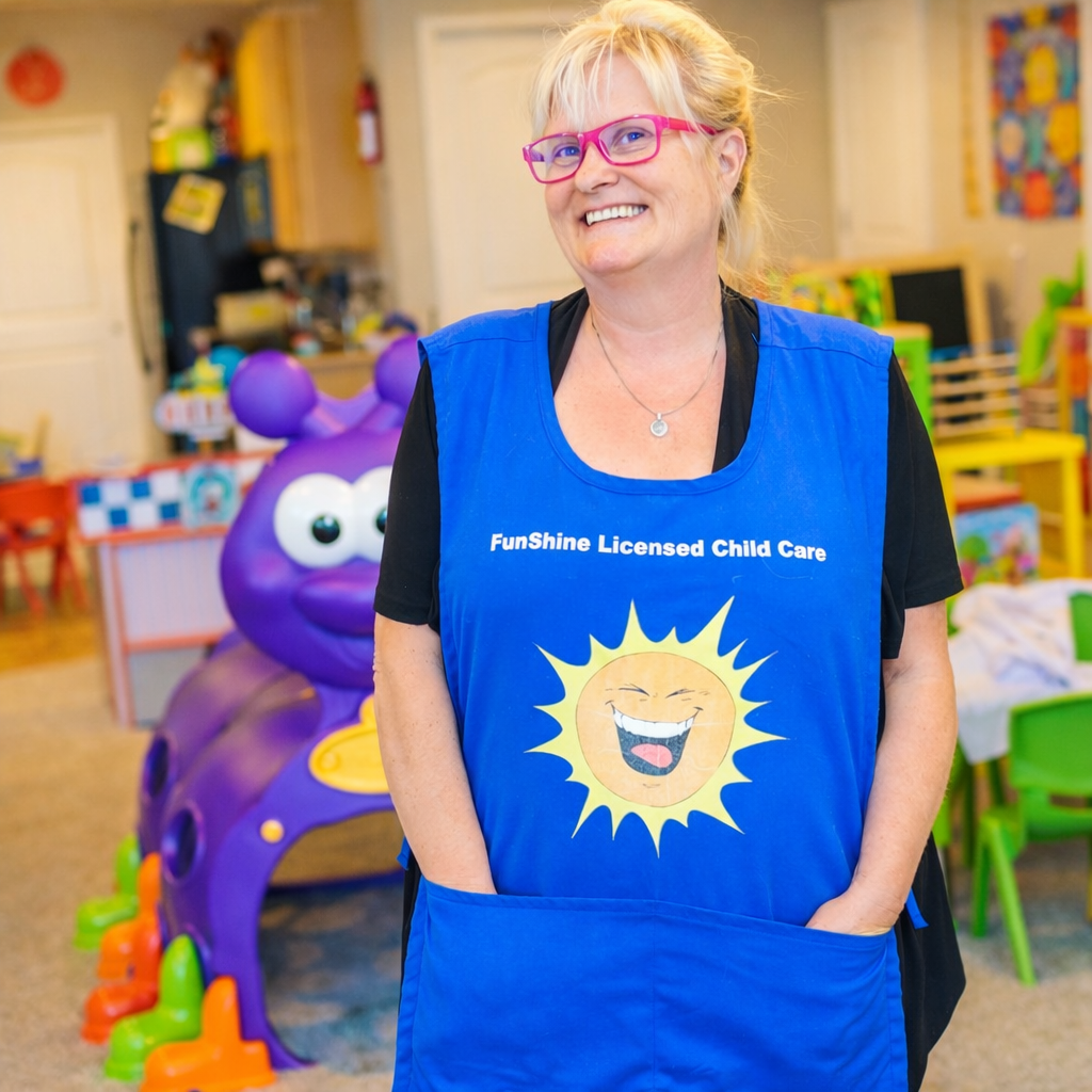 Miss Chris in her Funshine Licensed Child Care apron at the daycare